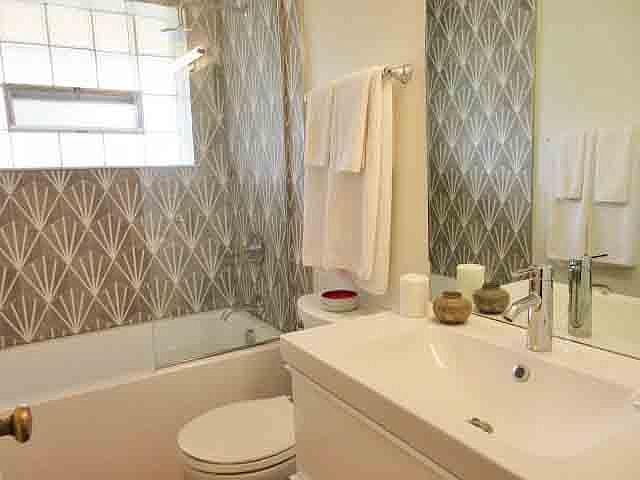 all new bath with soaking tub, custom tile, new vanity and sink.
