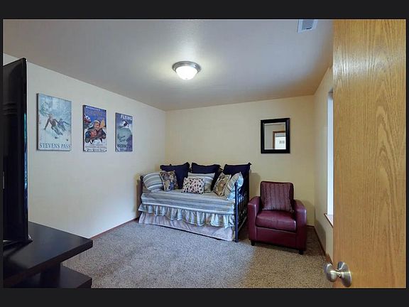 bonus room, just off the front door. Could be fourth bedroom, hangout room, office. set up currently with two twins. One is a trundle, and large TV and easy chair.
