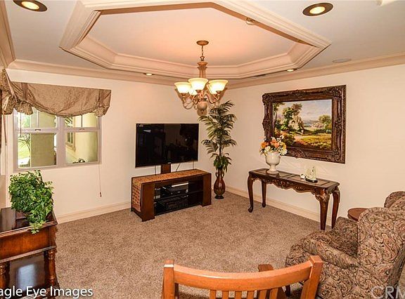 Media room has built-in surround sound speakers with recessed dim-able lighting and crown molding an
