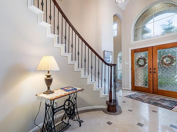Double leaded front doors and wrought iron balusters on the stairs.