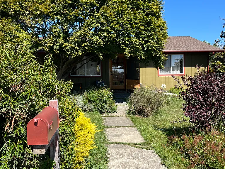 The home was built in 1970, with added on rooms in 1980. There are several skylights in the living room, large windows and both sliding doors and French doors creating an open feeling throughout. The garden is filled with shrubs and trees.