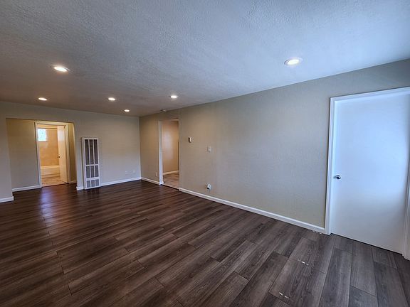 Enter into living room. Office/den (same bedroom) to the right, kitchen on the left.