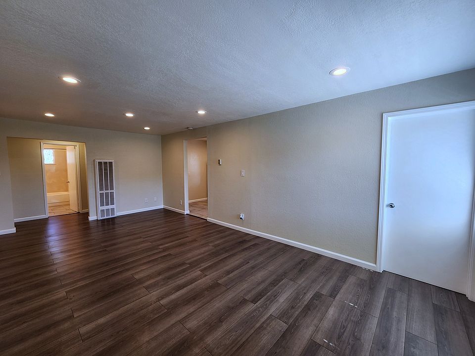 Enter into living room. Office/den (same bedroom) to the right, kitchen on the left.