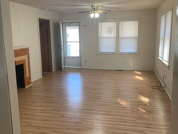 LIVING ROOM LOOKING OUT TO FRONT DOOR FROM KITCHEN