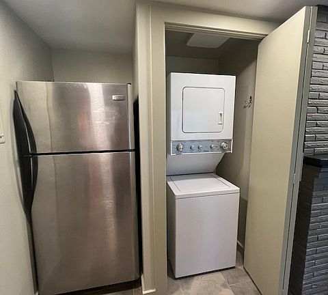 Refrigerator next to the washer dryer unit.