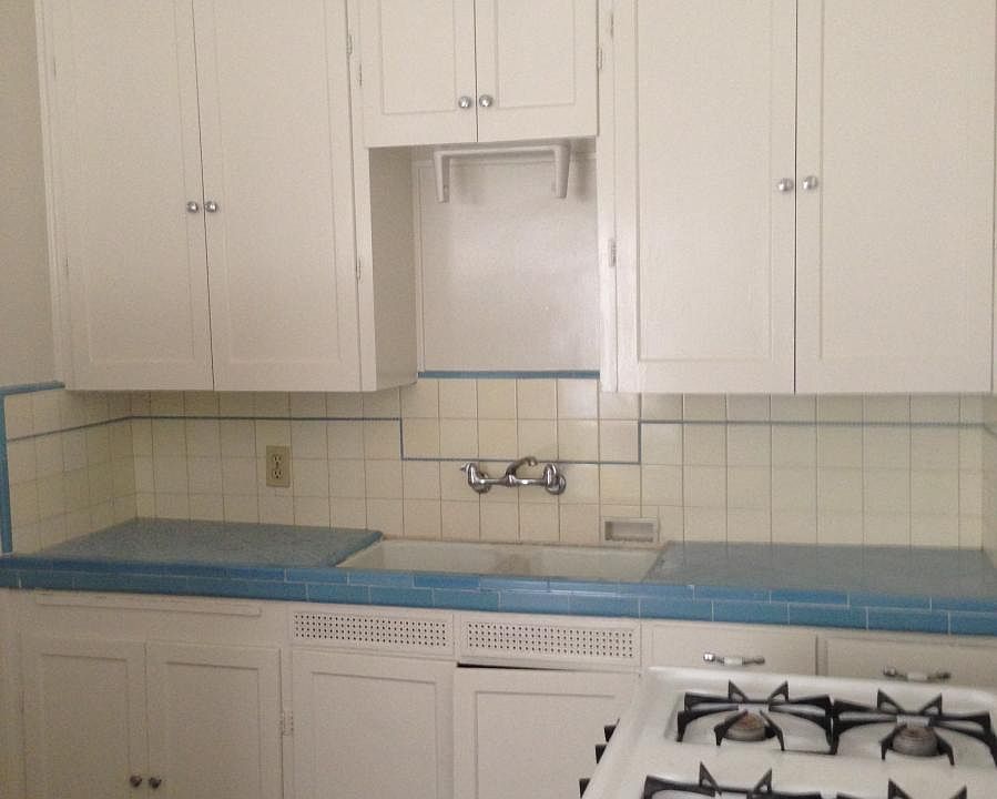 kitchen with original tile and cabinets