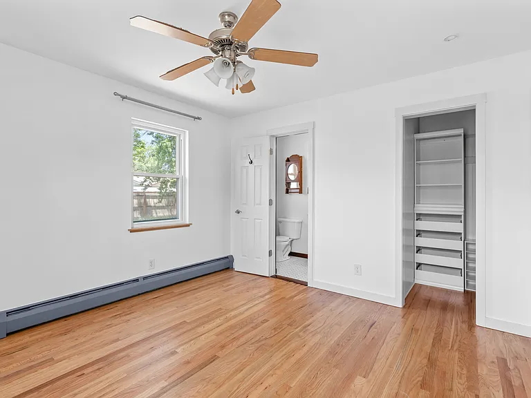 The primary suite features hardwood floors, great natural light, full private ensuite, and walk-in closet.