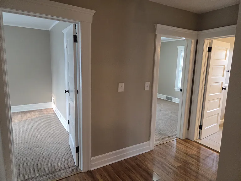 Hallway-Bedroom doors and bathroom door on the left.