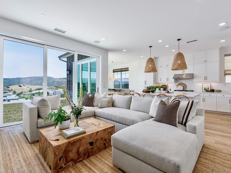 Grand open concept living room, kitchen and dining room. Two sets of tri-sliders create easy indoor/outdoor feel.