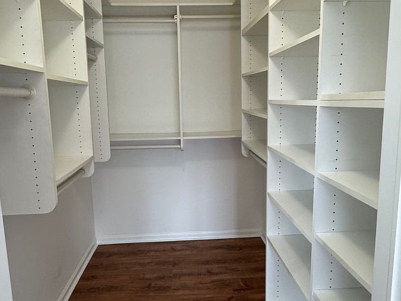 Custom closet in primary bedroom suite
