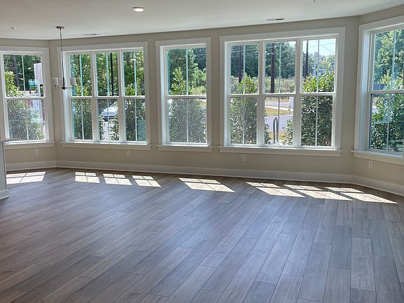 Light-filled great room. Blinds will be installed. Luxury vinyl plank flooring throughout condo.