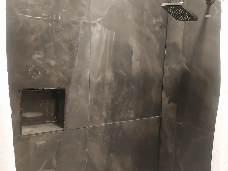 Beautiful black porcelain wall for tub and shower. Fixtures are black (modern)