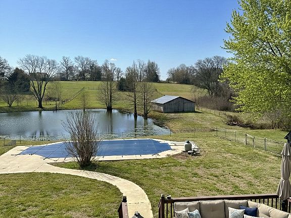 This is the view from the house window out back. The 2 acres are mostly in back and go all the way to the trees in the distance.
