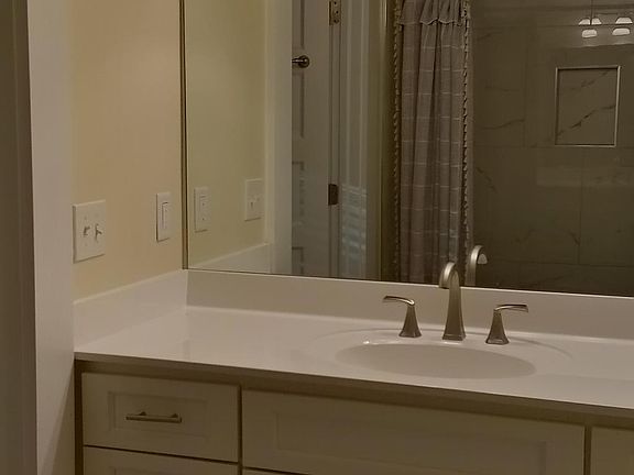 Bathroom with full size mirror and plenty of counter space and storage