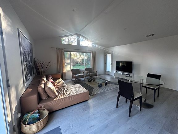 Bright & airy Living room w/ flat screen TV (streaming included).
Dining area w/ seating for two.