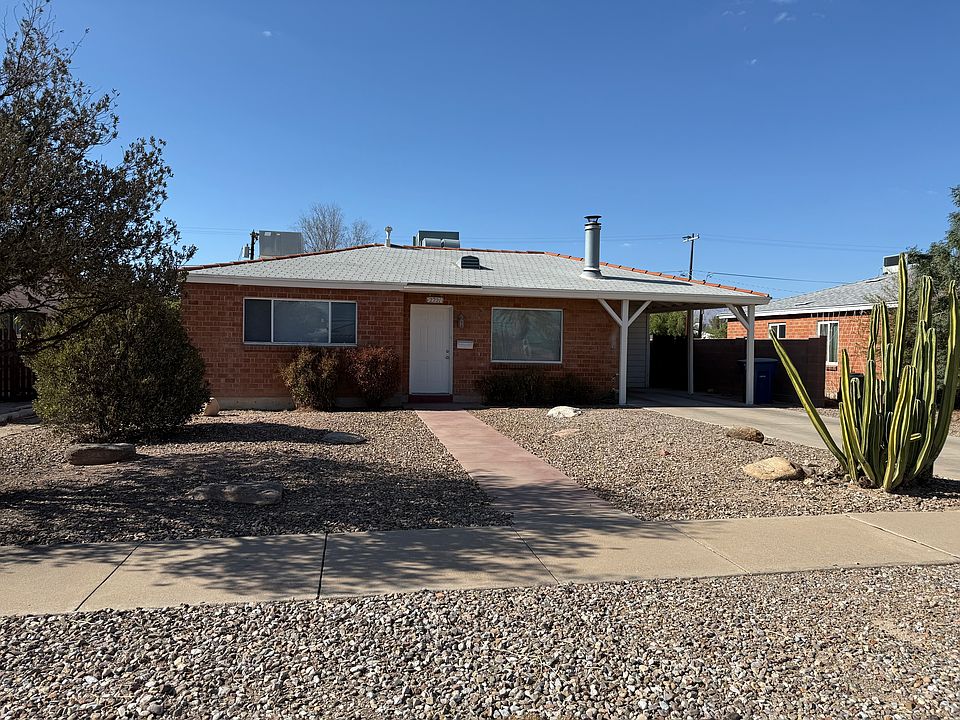 Front of House, desert landscape, driveway and carport