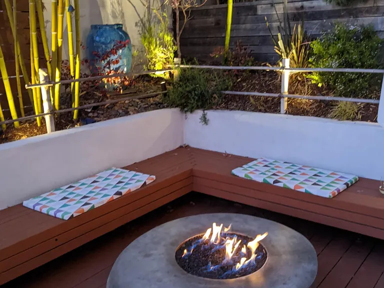 Rear deck - fire pit at night, with landscape lighting