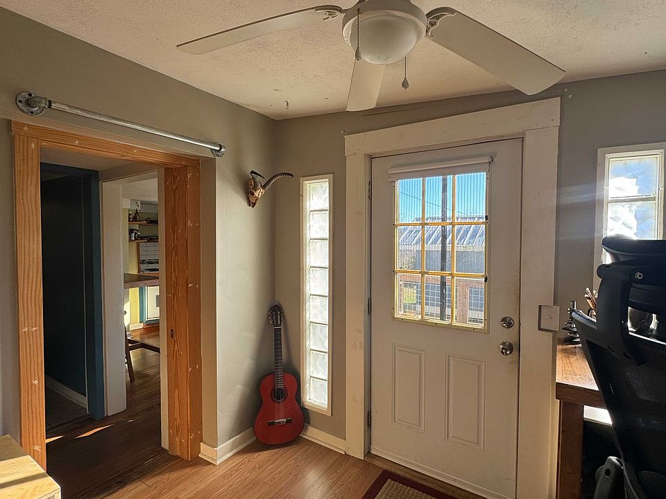 Sunny space being used as a bedroom/office space.