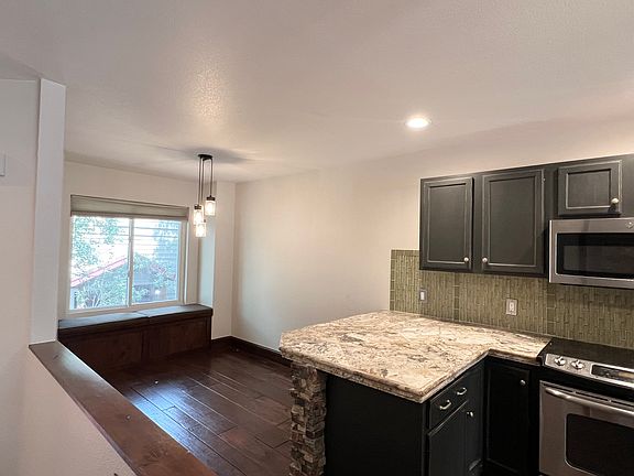 top of stairs, ldining room with bench seat, built in desk (not in photo) and coffee bar with built ins on other side (not in photo).