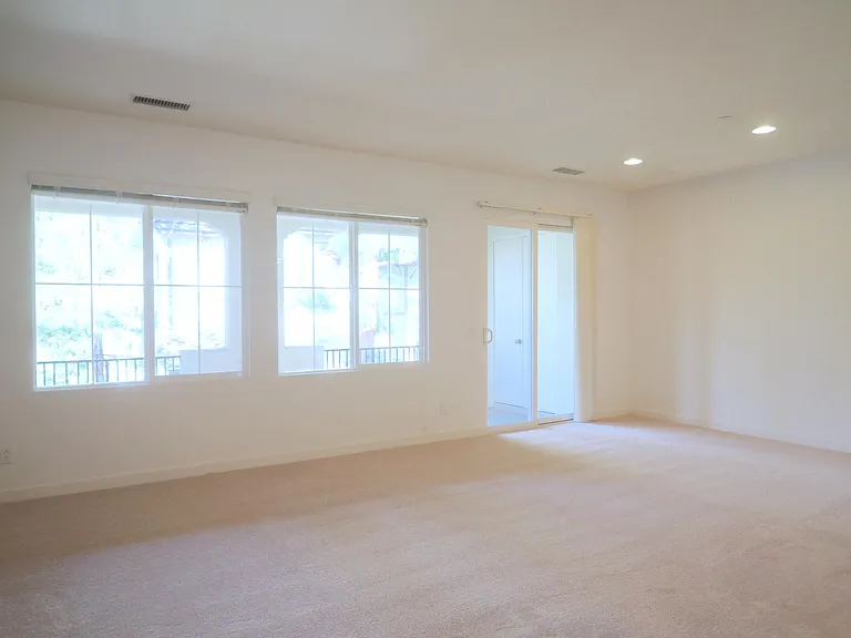 Living and dining room with sliding glass door to the balcony