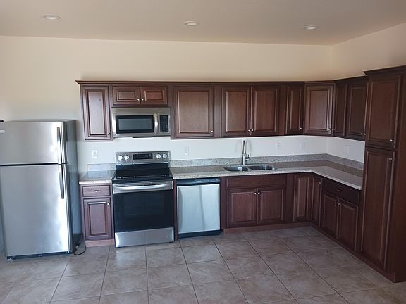 Kitchen with refrigerator, oven microwave and dishwasher