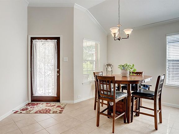 Step inside to find beautiful tile floors, soft neutral paint, raised ceilings with thick crown molding, and spectacular natural light from windows scattered throughout.