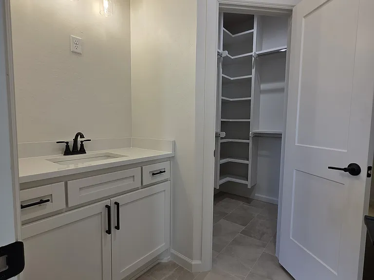Jack & Jill entrance vanity area and walk-in closet to shared bath/toilet