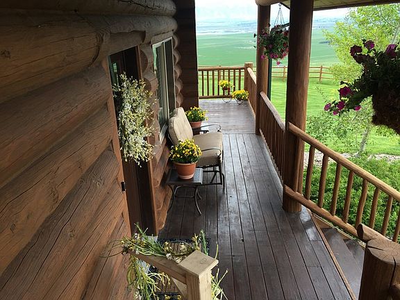 Welcoming Front Entry : Big 12" logs and wood deck complement the natural beauty of Cache Valley