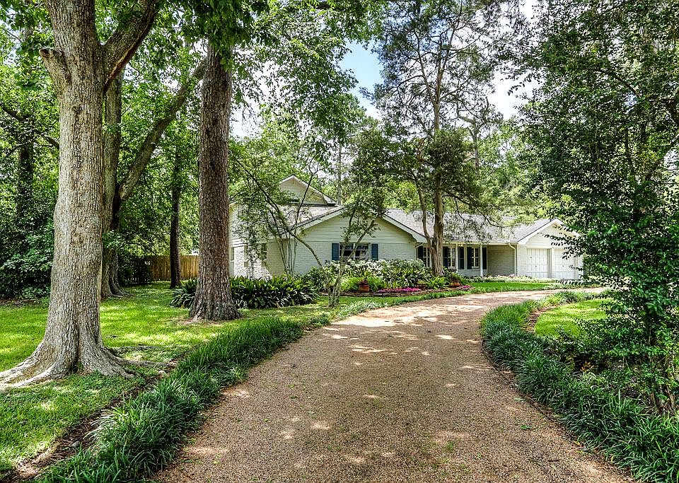 Graceful gravel drive winds through majestic trees and lush landscaping. No MUD taxes and no HOA. Perfect home for the family w remodeled elementary in walking distance and great home and yard for entertaining.