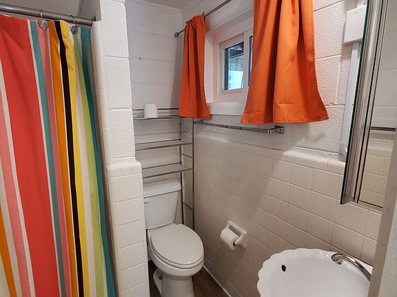 Small bathroom with new sink and toilet. All floors are new luxury vinyl.