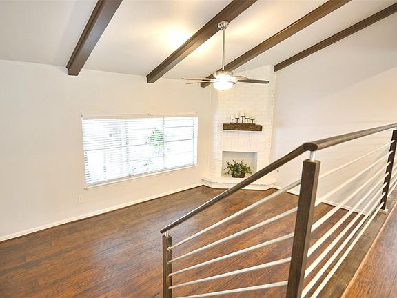 Split Level Family Room. Beamed ceilings and steel railings on the custom stairs!