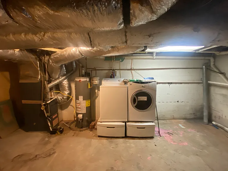 Huge basement laundry area and storage space.