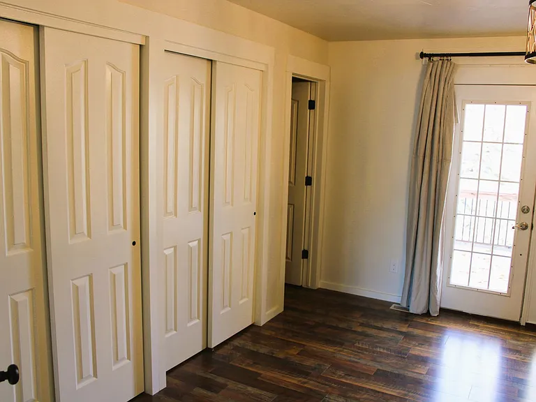 Master bedroom with French door leading to outdoor deck