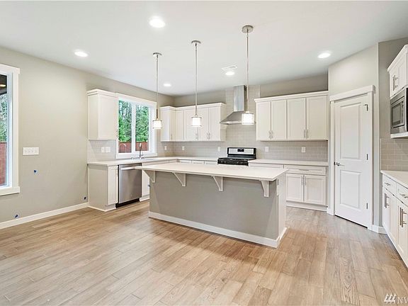 Kitchen will be similar with white cabinets and vent hood