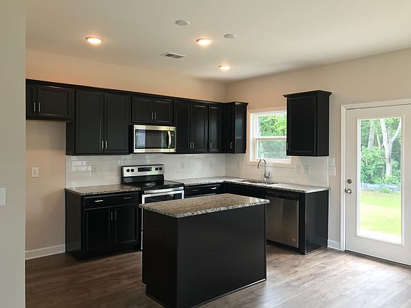 Stunning Kitchen with Stainless, Hardwood, Granite, and Espresso Cabinets