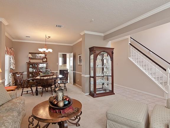 This elegant formal dining room includes crown & chair rail moulding, beautiful paint tones and a ch