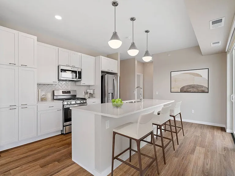 Modern kitchen with counter dining at The Hallon Luxury Apartments in Hopkins MN