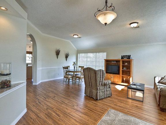 Living room accessories with crown moulding, and chair rails, and distressed  Pecan flooring.