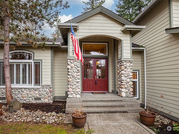 The entry showing the covered porch and stone trim accenting.>