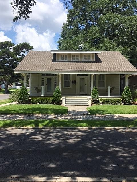 Front of house with one bedroom door entrance on right side of porch.