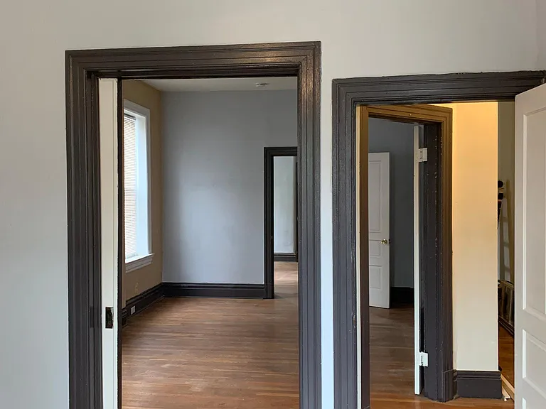 Master bedroom looking toward second bedroom through pocket door.