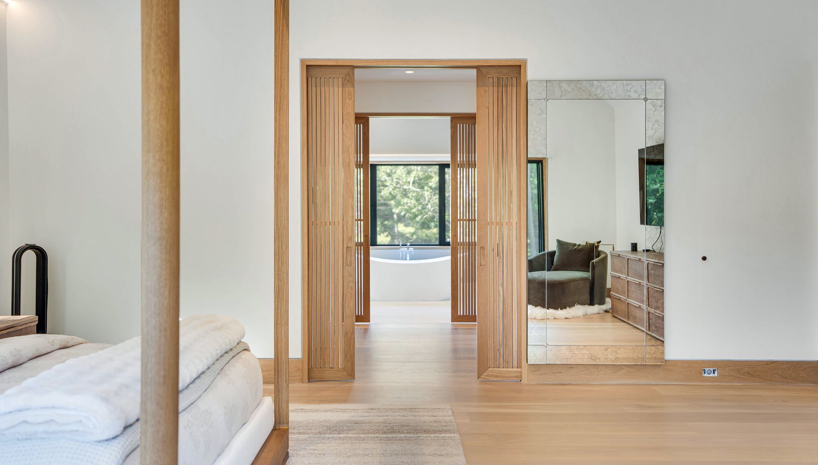  2nd floor primary suite hallway which leads to his & hers custom closets then to the bathroom