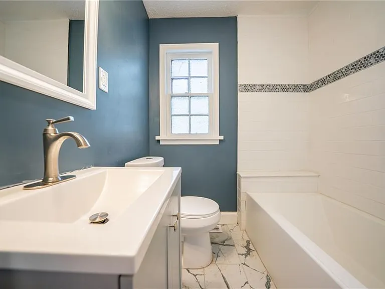 Updated full bathroom with tub.