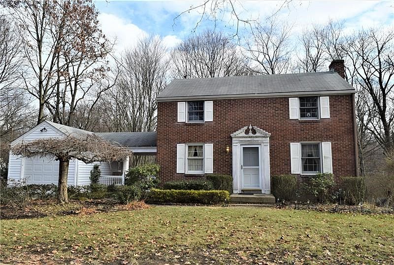 Charming brick home with breezeway and one car garage.