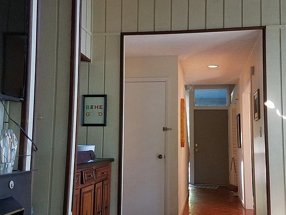 Looking from the living room towards the front door. The dining room is on the right half way to the door