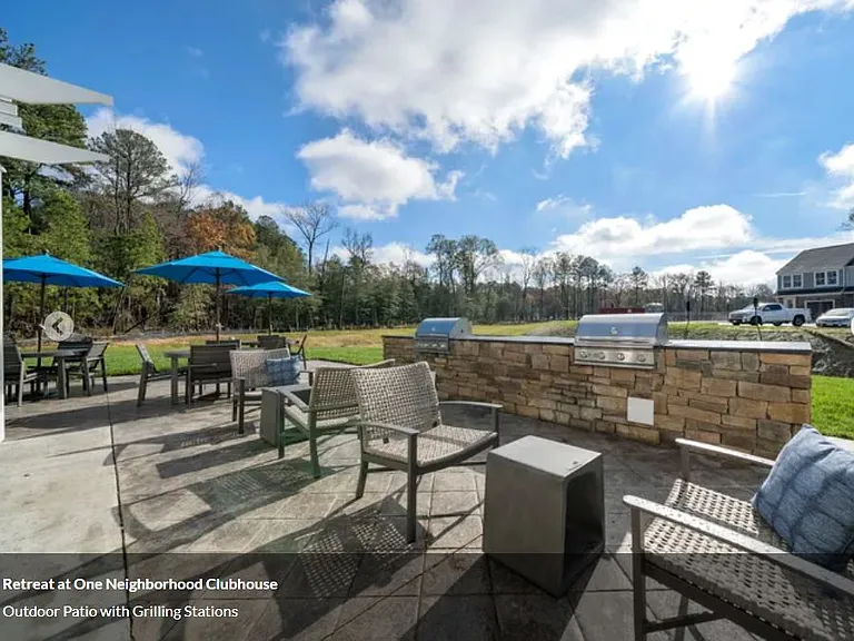 with a large patio, double-sided fireplace, yard games, and grilling stations.