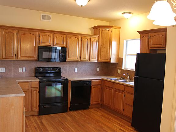 Kitchen with stove, hanging over microwave, dishwasher, and 