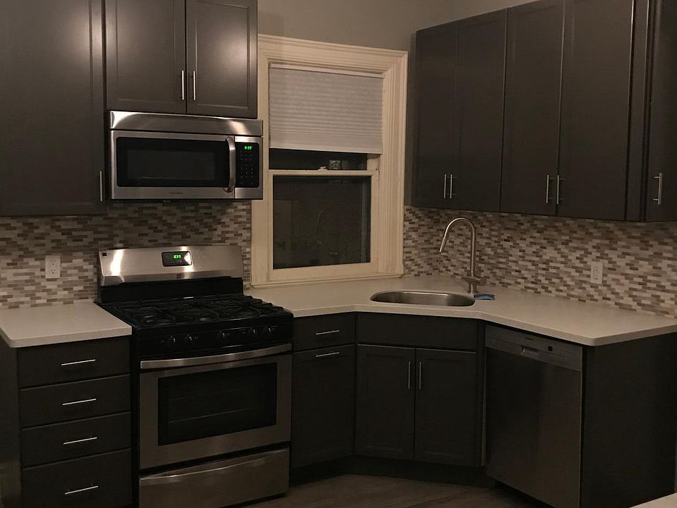 Kitchen with refinished floor, new appliances, tile backspla