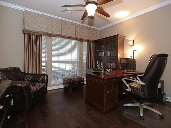 The study overlooks the front yard, and is separated from the home by French doors.