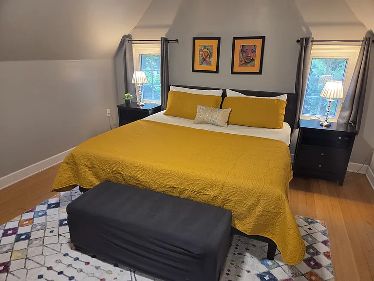 Features a comfortable King bed, two nightstands, a seating area, and two ample closets, all complemented by a private en-suite bathroom.